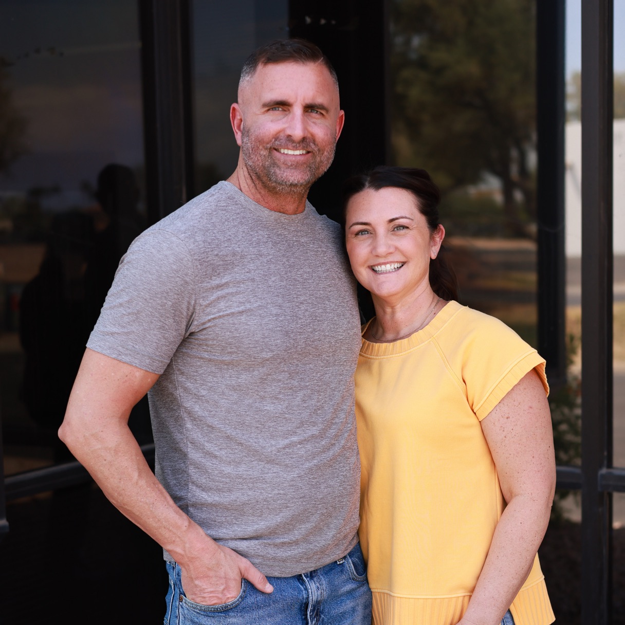 The two founders of Kristi Marie Creative, standing together outside the showroom.